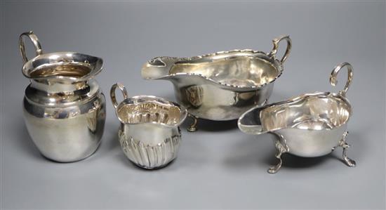 Two George V silver sauceboats and two earlier silver cream jugs, 9.5 oz.